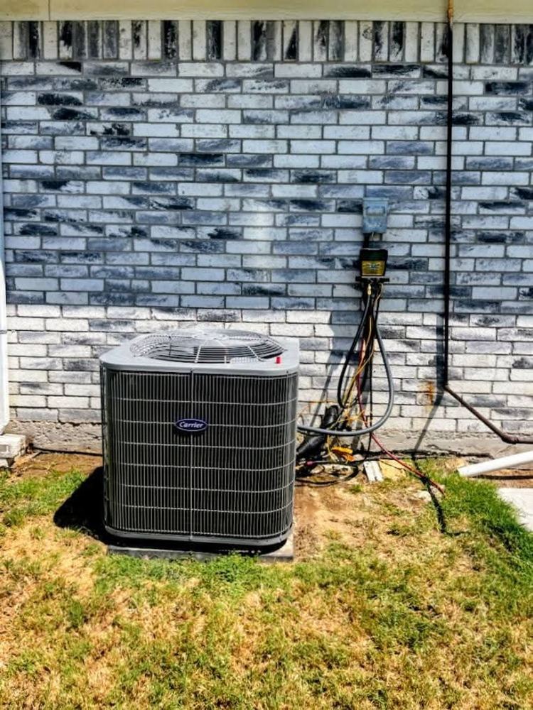 Carrier condenser installed by a brick wall