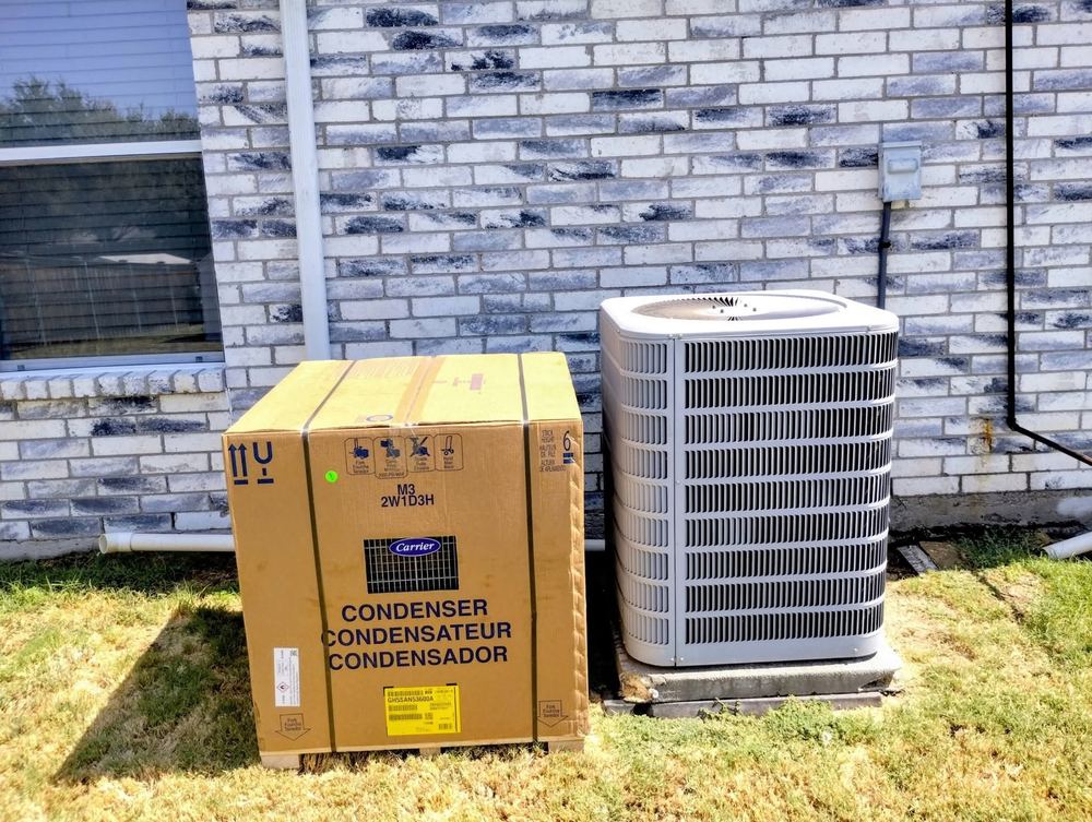 New Carrier condenser beside its shipping box