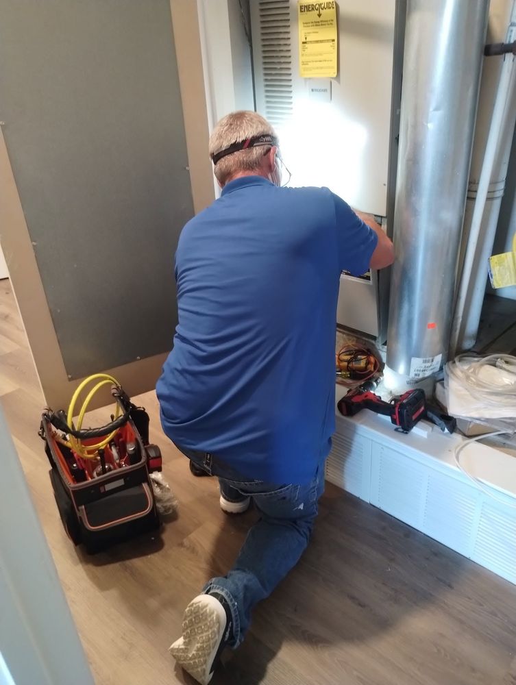 DM Mechanical tech servicing a furnace